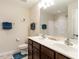 Inviting bathroom features a double sink vanity with dark wood cabinets and a walk-in shower at 4179 Dunkirk Dr, Burlington, NC 27215