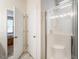 Clean bathroom showcasing a glass-enclosed shower with a built-in seat and a view to the bedroom at 4179 Dunkirk Dr, Burlington, NC 27215