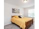 Serene bedroom features a wood bed frame, a bright window, and beach-themed art at 4179 Dunkirk Dr, Burlington, NC 27215