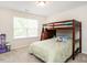 Comfortable bedroom with a bunk bed, a large window with natural light, and playful decorations at 4179 Dunkirk Dr, Burlington, NC 27215