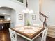 Open dining area featuring hardwood floors, staircase and stylish table with seating at 4179 Dunkirk Dr, Burlington, NC 27215