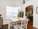 Cozy dining area featuring a chandelier, hardwood floors, and views into the kitchen at 4179 Dunkirk Dr, Burlington, NC 27215