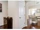 Inviting hallway entrance leads to a bright dining area, showcasing hardwood floors and an open, airy design at 4179 Dunkirk Dr, Burlington, NC 27215