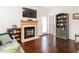 Charming living room with a fireplace, hardwood floors, and tasteful decor creating a welcoming and comfortable ambiance at 4179 Dunkirk Dr, Burlington, NC 27215