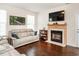 Cozy living room featuring a fireplace, hardwood floors, and a neutral color palette for a warm and inviting atmosphere at 4179 Dunkirk Dr, Burlington, NC 27215