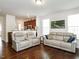 Spacious living room with hardwood floors, comfortable seating, and seamless flow into the adjacent kitchen at 4179 Dunkirk Dr, Burlington, NC 27215