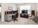 Functional office space features a desk setup, comfortable seating, and natural light from a window at 4179 Dunkirk Dr, Burlington, NC 27215