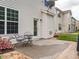 Exterior patio with table set, beautiful landscaping, and house with white vinyl siding at 4179 Dunkirk Dr, Burlington, NC 27215