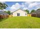 Spacious backyard featuring a well-maintained lawn, wooden fence, and rear view of the home at 418 Lodestone Dr, Durham, NC 27703