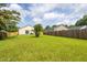Expansive backyard with green grass and a wooden fence surrounding the property at 418 Lodestone Dr, Durham, NC 27703