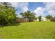 Lush backyard with a healthy lawn, bordered by a wooden fence and mature trees at 418 Lodestone Dr, Durham, NC 27703