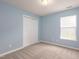 Bright bedroom featuring a window, neutral carpet, and a closet at 418 Lodestone Dr, Durham, NC 27703
