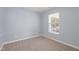 Cozy bedroom with soft carpet and a bright window at 418 Lodestone Dr, Durham, NC 27703
