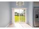 Bright dining area with tile flooring and sliding doors to a large lawn, adjacent to the kitchen at 418 Lodestone Dr, Durham, NC 27703