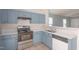 Updated kitchen featuring subway tile backsplash, stainless steel appliances, and a dual basin sink at 418 Lodestone Dr, Durham, NC 27703