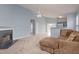 Inviting living room with an open floor plan featuring a fireplace and a view into the kitchen at 418 Lodestone Dr, Durham, NC 27703