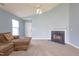 Comfortable living room featuring a fireplace, neutral carpet, and a view of the front entry at 418 Lodestone Dr, Durham, NC 27703