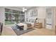 Bright bedroom features large window, modern lighting, neutral colors, and ensuite bathroom at 429 Shinleaf Pond Trl, Raleigh, NC 27614