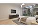 This bedroom features sleek modern design, with media center, and large windows at 429 Shinleaf Pond Trl, Raleigh, NC 27614