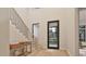Inviting entryway with modern staircase, stylish console table, and ample natural light at 429 Shinleaf Pond Trl, Raleigh, NC 27614