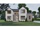 Stunning exterior elevation featuring a modern design with black window frames and neutral color palette at 429 Shinleaf Pond Trl, Raleigh, NC 27614