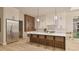 Spacious kitchen with a large island, modern pendant lighting, and stainless steel appliances at 429 Shinleaf Pond Trl, Raleigh, NC 27614