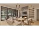 Open-concept living room featuring a cozy fireplace, built-in shelving, and seamless access to the patio at 429 Shinleaf Pond Trl, Raleigh, NC 27614