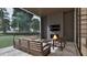 Outdoor patio with a stone floor, comfortable seating, a fireplace, and an outdoor entertainment area at 429 Shinleaf Pond Trl, Raleigh, NC 27614