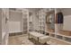 Spacious walk-in closet with custom shelving and storage solutions and seating at 429 Shinleaf Pond Trl, Raleigh, NC 27614