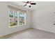 Bedroom with large windows, ceiling fan, and neutral carpeting at 45 Glen Bend Ct, Spring Lake, NC 28390