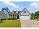 Lovely one-story home with light blue siding, dormer windows, and a two-car garage on a sunny day at 45 Glen Bend Ct, Spring Lake, NC 28390