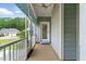 Covered front porch with neutral concrete flooring, ceiling fan, and blue privacy screens at 45 Glen Bend Ct, Spring Lake, NC 28390