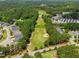 Aerial view showing a lush golf course, complete with pond and sand trap, adjacent to a lovely community at 45 Glen Bend Ct, Spring Lake, NC 28390