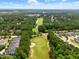 Aerial view showing a lush green golf course surrounded by trees and homes in a residential neighborhood at 45 Glen Bend Ct, Spring Lake, NC 28390