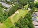 An aerial view shows the golf course, surrounded by trees and landscaping, next to a residential community at 45 Glen Bend Ct, Spring Lake, NC 28390