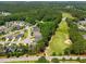 Aerial view showing a lush golf course next to a residential community with mature trees lining the street at 45 Glen Bend Ct, Spring Lake, NC 28390