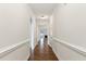 Long hallway features hardwood floors, light walls, and doorways leading to other rooms in the house at 45 Glen Bend Ct, Spring Lake, NC 28390