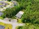 Aerial view of community clubhouse, pool with lounge chairs, parking area, and lush surrounding trees at 45 Glen Bend Ct, Spring Lake, NC 28390