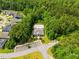 Aerial view of community clubhouse, pool with lounge chairs, parking area, and lush surrounding trees at 45 Glen Bend Ct, Spring Lake, NC 28390