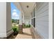 Covered porch showcases stone-accented columns, siding, and a glimpse of the neighborhood beyond at 45 Glen Bend Ct, Spring Lake, NC 28390