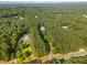 Aerial view displaying the home nestled among lush trees and manicured grounds at 457 Poplar Forest Ln, Pittsboro, NC 27312