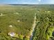 Expansive aerial view showcasing the home and neighborhood surrounded by abundant trees at 457 Poplar Forest Ln, Pittsboro, NC 27312