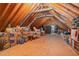 Spacious unfinished attic with exposed rafters, storage boxes, and natural light at 457 Poplar Forest Ln, Pittsboro, NC 27312