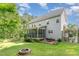 Spacious backyard features a fire pit, lush greenery, and a charming outdoor patio area for entertaining at 457 Poplar Forest Ln, Pittsboro, NC 27312