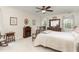 Comfortable bedroom with fireplace, ceiling fan, and dresser with decorative mirror at 457 Poplar Forest Ln, Pittsboro, NC 27312
