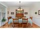 Elegant dining room featuring hardwood floors, chandelier, and traditional furnishings at 457 Poplar Forest Ln, Pittsboro, NC 27312