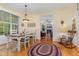 Cozy dining area with a table set for four, lots of light, and views to the living room at 457 Poplar Forest Ln, Pittsboro, NC 27312