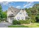 Well-maintained two-story home with attached garage, blue shutters, and mature trees at 457 Poplar Forest Ln, Pittsboro, NC 27312