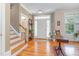 Welcoming foyer with hardwood floors, staircase, natural light and traditional decor at 457 Poplar Forest Ln, Pittsboro, NC 27312