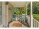 Relaxing front porch with rocking chairs, decorative rug, and a view of the peaceful surroundings at 457 Poplar Forest Ln, Pittsboro, NC 27312